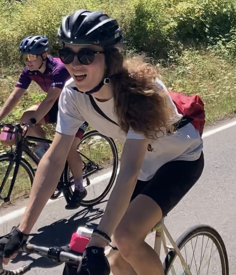 Amelia riding her bike, smiling at the camera